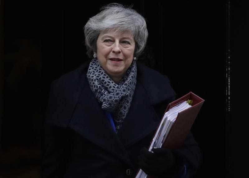 Theresa May leaves 10 Downing Street after British lawmakers overwhelmingly rejected her divorce deal with the EU.