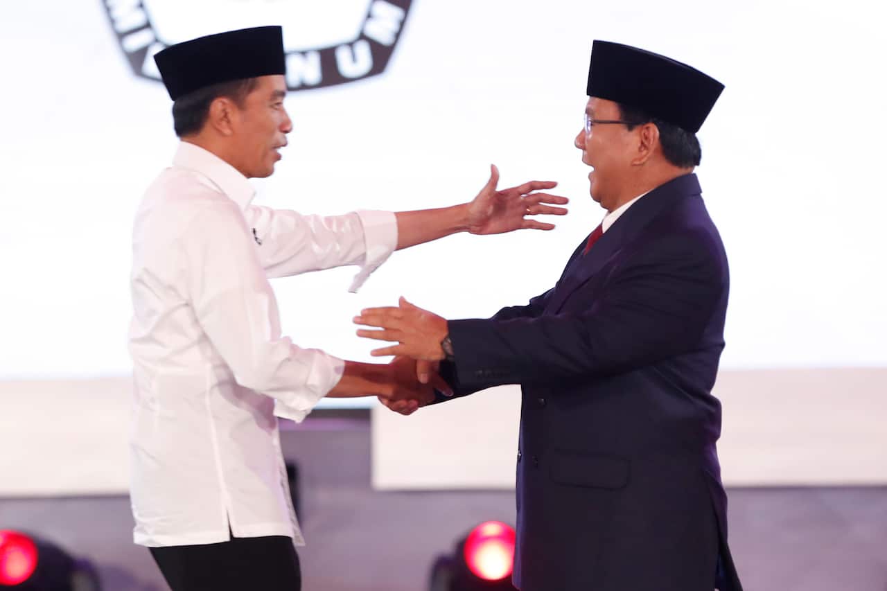 Presidential candidate Joko Widodo (L) shakes hand with Presidential candidate Prabowo Subianto (R) during a debate among candidates in Jakarta, Indonesia.