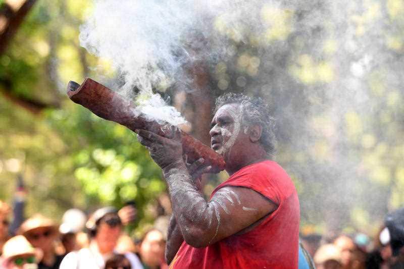 Raymond 'Bubbly' Weatherall leads an Indigenous smoking ceremony during the Sydney rally.