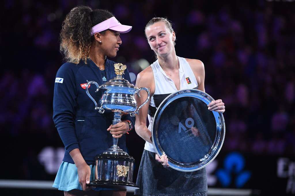 Naomi Osaka holds the Australian Open trophy alongside Petra Kvitova