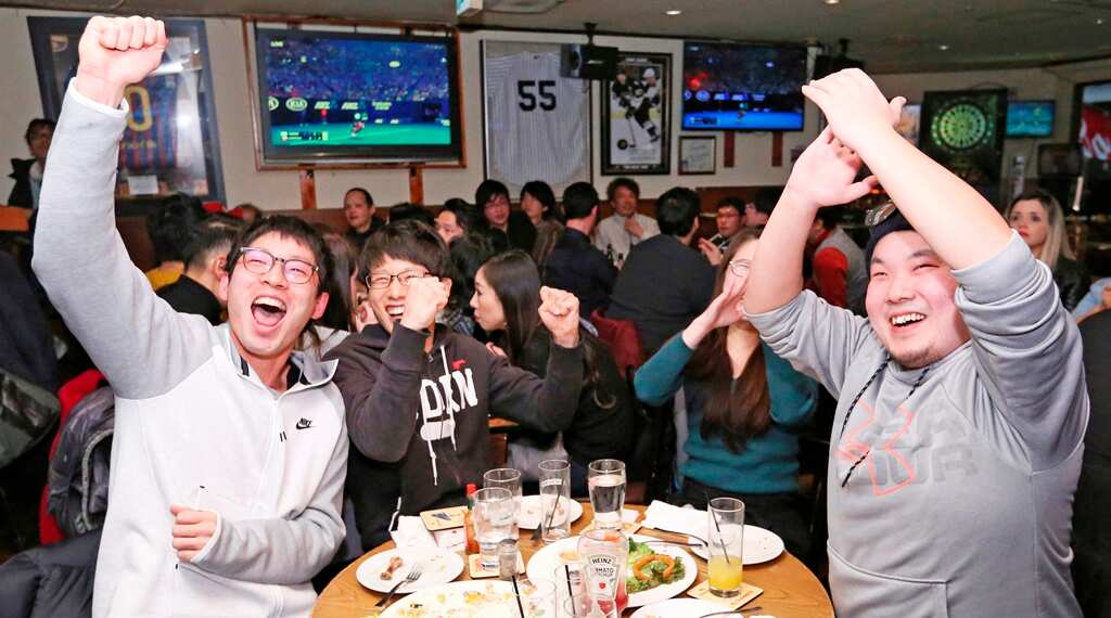 People celebrate just after Naomi won the final match of the Australian Open tennis tournament between Osaka Naomi and Petra Kvitov at a sport bar in Nagoya City, Aichi