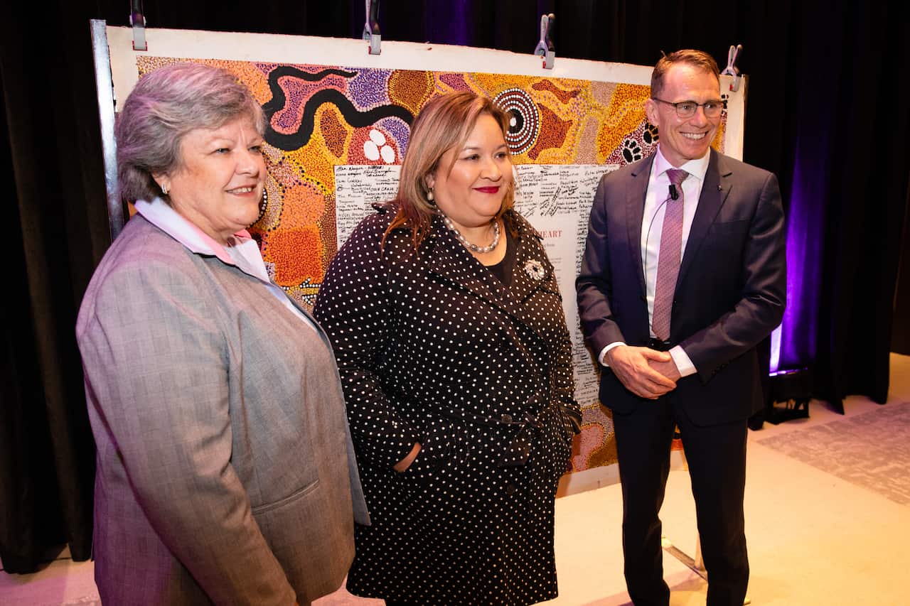 UNSW Sydney Professor Megan Davis (C) poses for a photograph next to the original Uluru Statement.