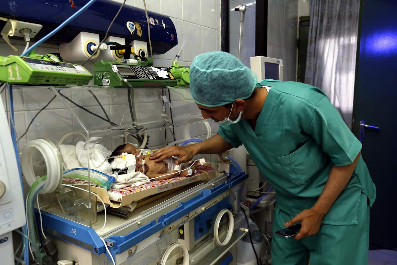 A Yemeni medic checks up on the newborn boys. 