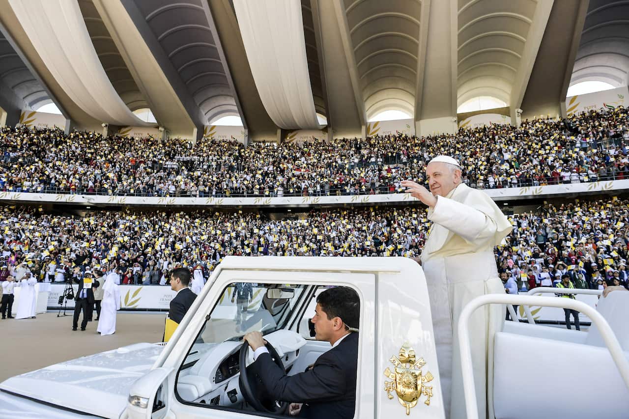 Pope Francis greets the faithfuls as he arrive to celebrate a Mass at the Sheikh Zayed Sports City in Abu Dhabi, United Arab Emirates.