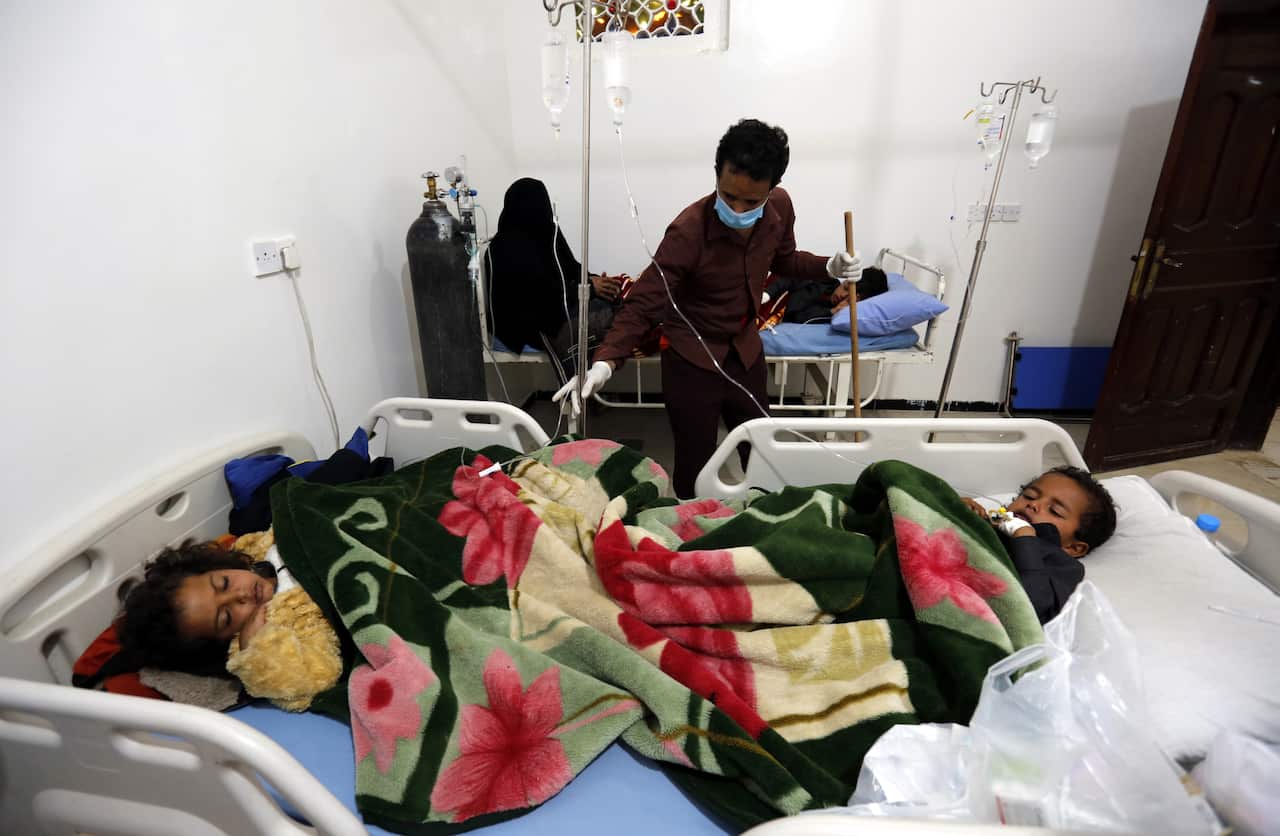 Yemeni children suffering from measles share a bed as they receive medical treatment at a hospital amid a rapidly spreading measles outbreak, in Sanaa, Yemen