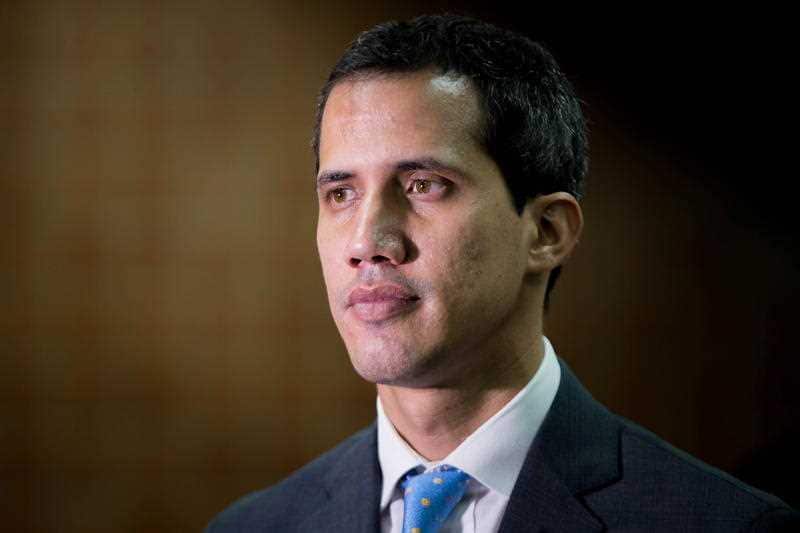 Juan Guaido, who proclaimed himself interim president of the country in January poses for photos.