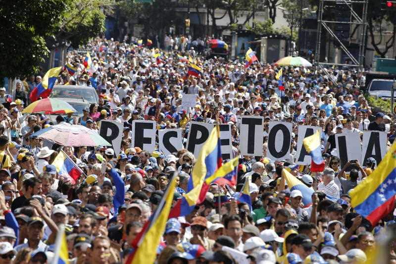 Thousands march against the government of Venezuela's President Nicolas Maduro, in Caracas, Venezuela, Tuesday, Feb. 12, 2019. 