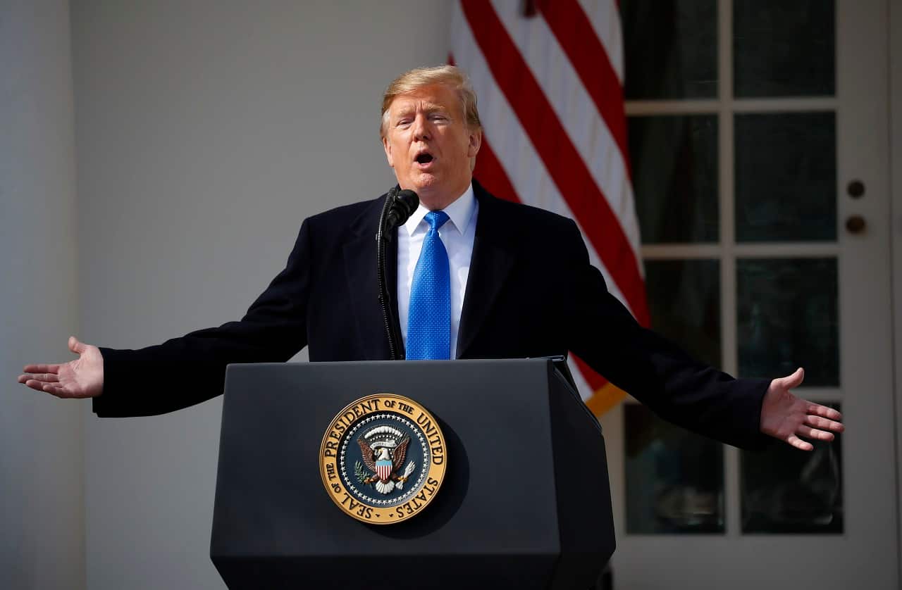 President Donald Trump talks to reporters.