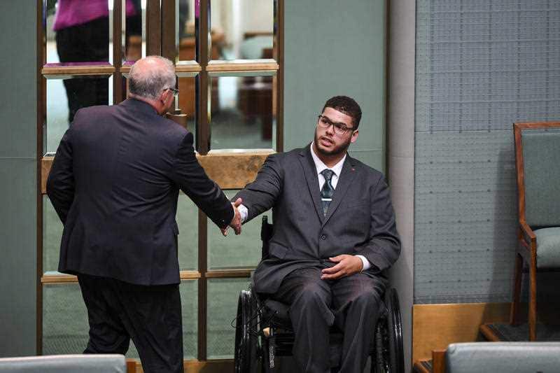 Jordon Steele-John (right) shakes hands with Scott Morrison (left) during the motion on the Disability Abuse Royal Comission