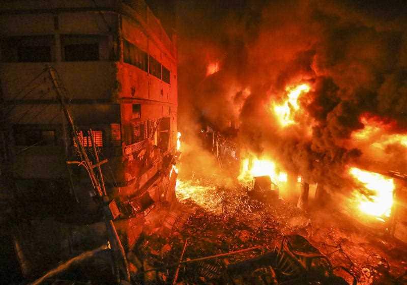 Flames rise from a fire in a densely packed shopping area in Dhaka, Bangladesh.