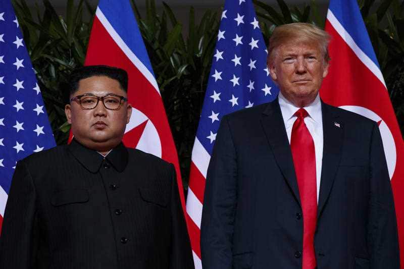 U.S. President Donald Trump stands with North Korean leader Kim Jong Un during their 2018 meeting on Sentosa Island, in Singapore.