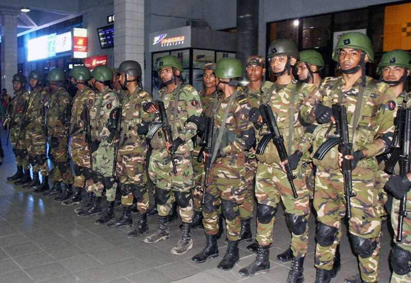 Bangladeshi security forces army member stand guard at the Shah Amanat International Airport in Chittagong