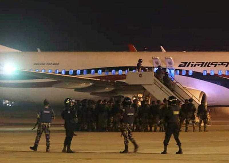 Police forces surround the hijacked Dubai-bound Bangladesh Biman Boeing 737-800 plane on the tarmac