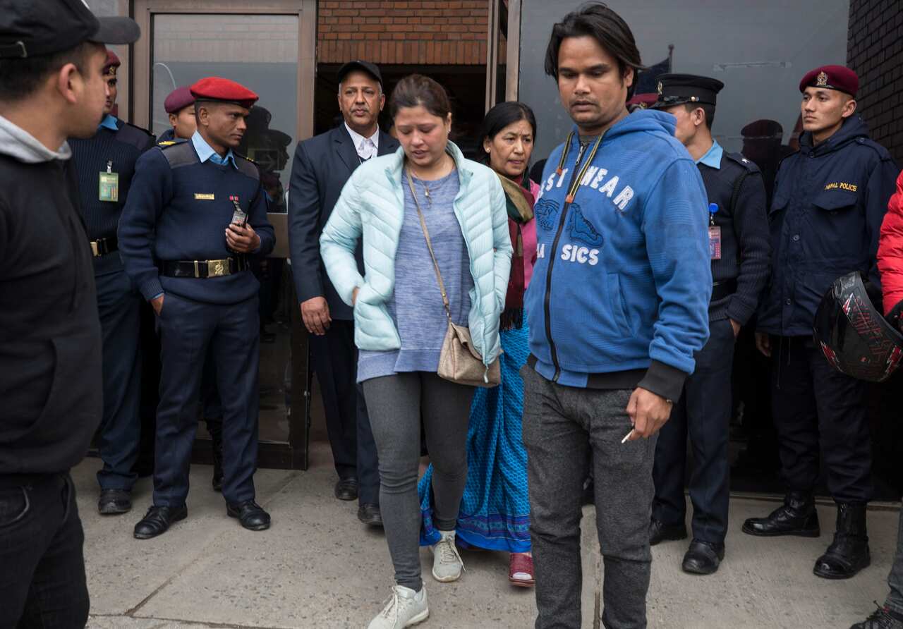 Family members of helicopter crash victims mourn at the International airport in Kathmandu, Nepal.