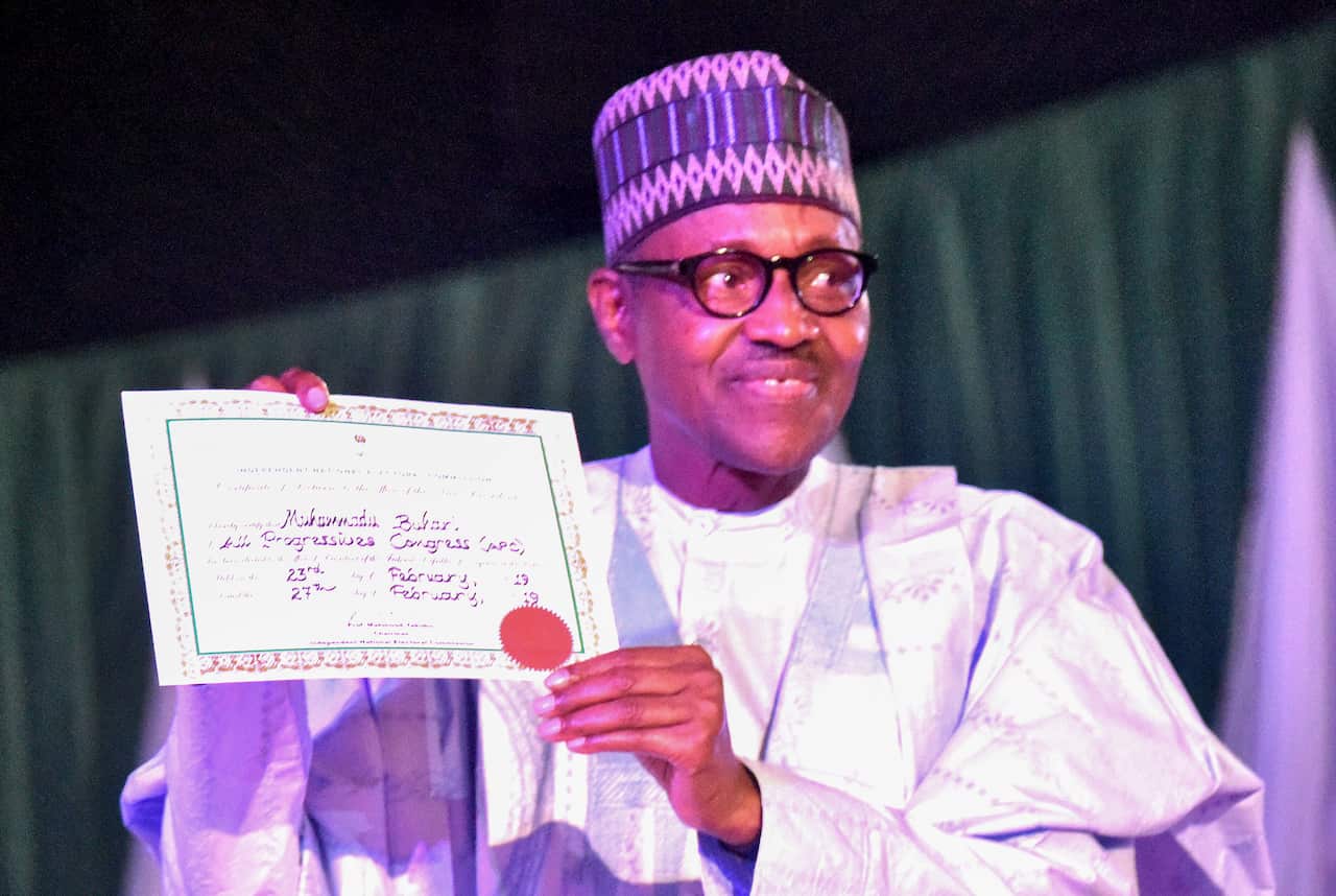 Nigerian President Muhammadu Buhari holds his certificate of return in Abuja, Nigeria.