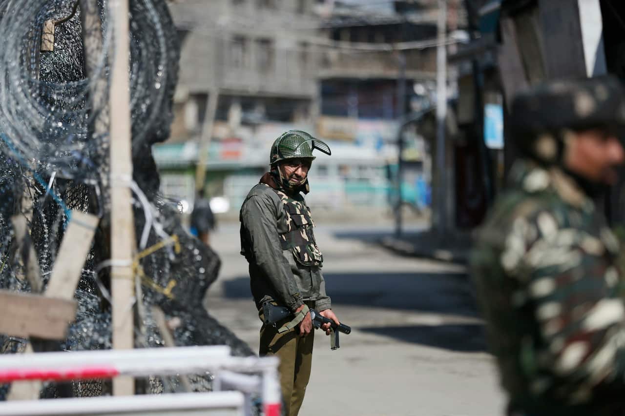 Indian paramilitary soldiers stand guard outside a closed market during a strike in Srinagar, India.