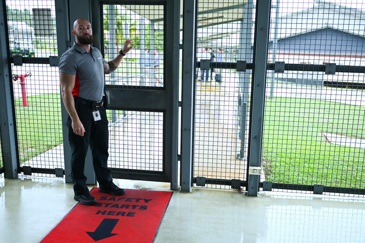 A guard is seen at the entry to the Christmas Island detention centre, where the family have lived for more than five months.