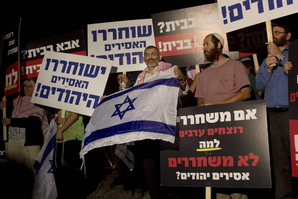 A 2013 file photo shows Israeli politician Michael Ben Ari, center, attending a demonstration against the release of Palestinian prisoners