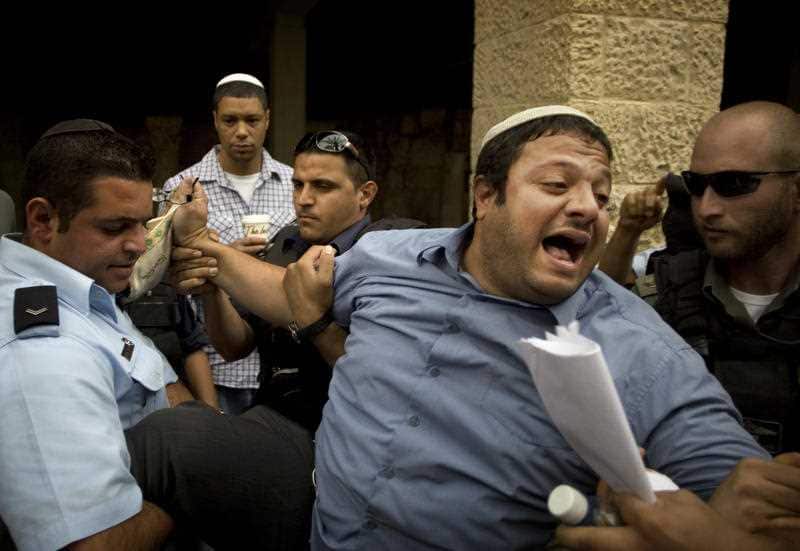 In this May 27, 2010 file photo, Itamar Ben-Gvir is detained by police after shouting slogans at White House Chief of Staff Rahm Emanuel