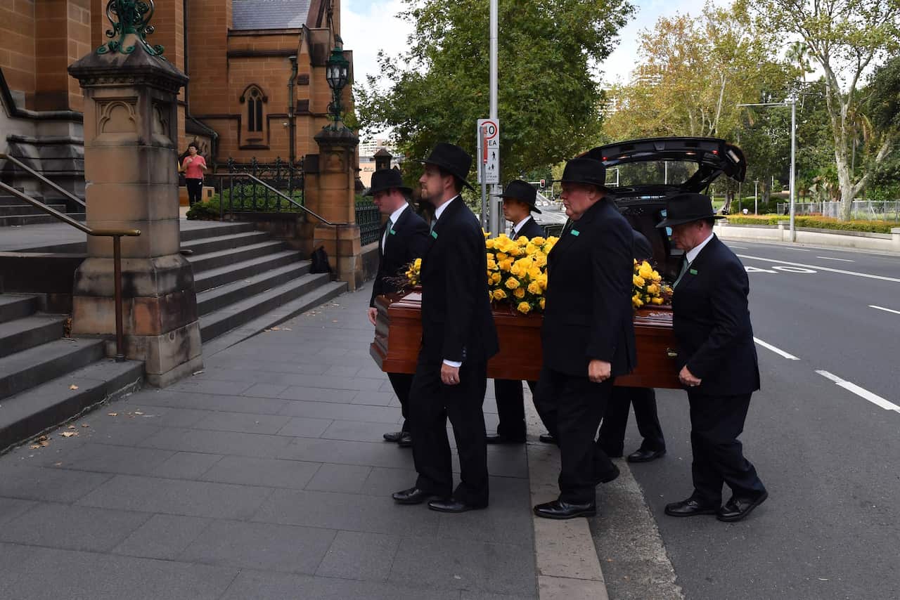 The casket for Mike Willesee is carried into St Mary's Cathedral for his Requiem Funeral Mass in Sydney, Friday, March 8, 2019. Mike Willesee passed away last week after a long battle with throat cancer. (AAP Image/Dean Lewins) NO ARCHIVING