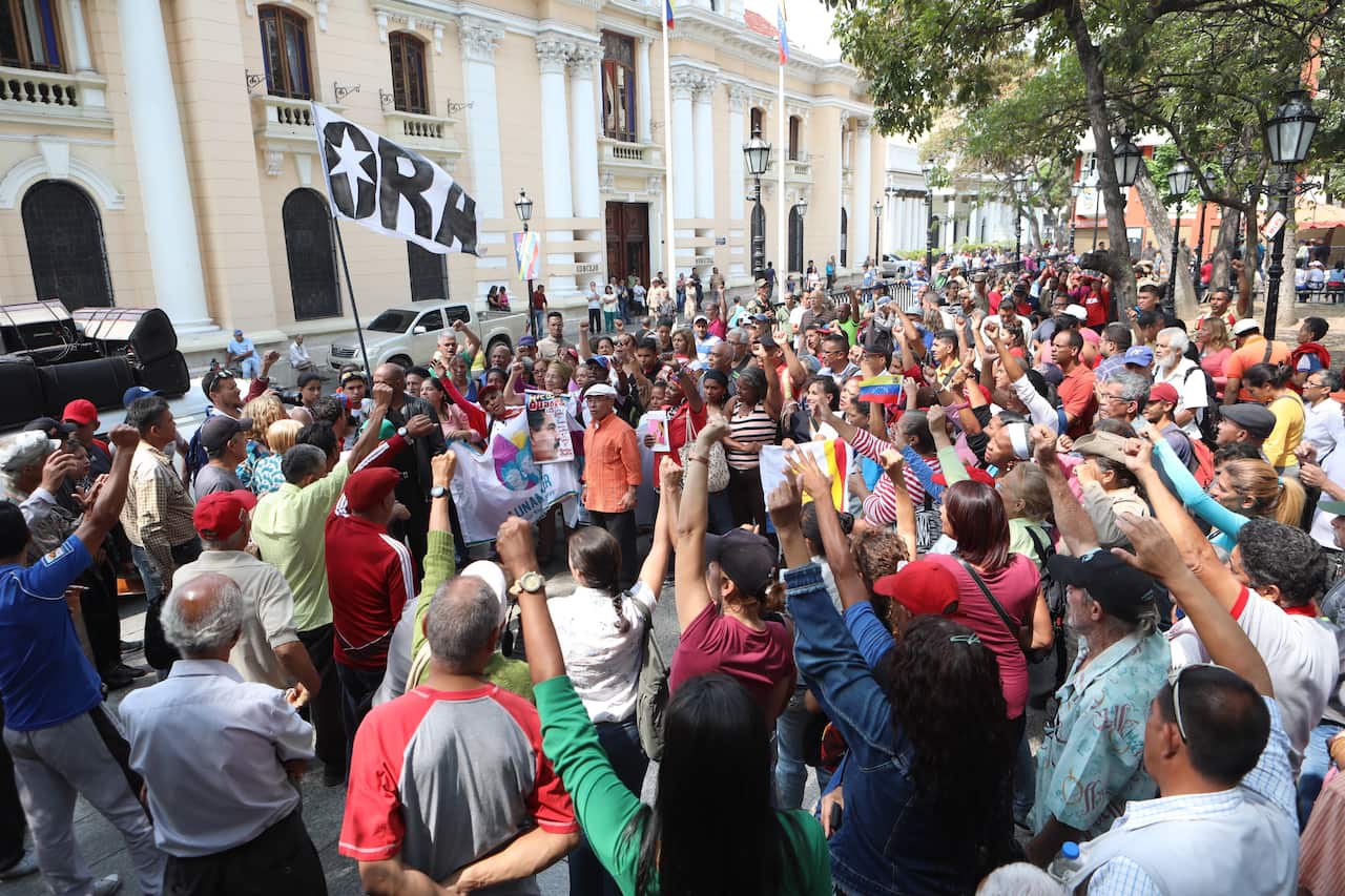 A group of people demonstrates in favor of President Maduro's Government,during a power outage in Caracas, Venezuela.