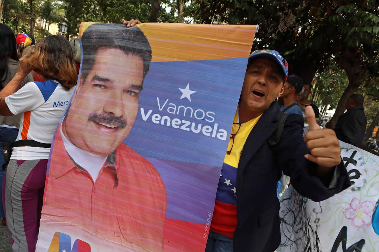 A group of people demonstrates in favor of President Maduro's Government, during a power outage in Caracas, Venezuela.