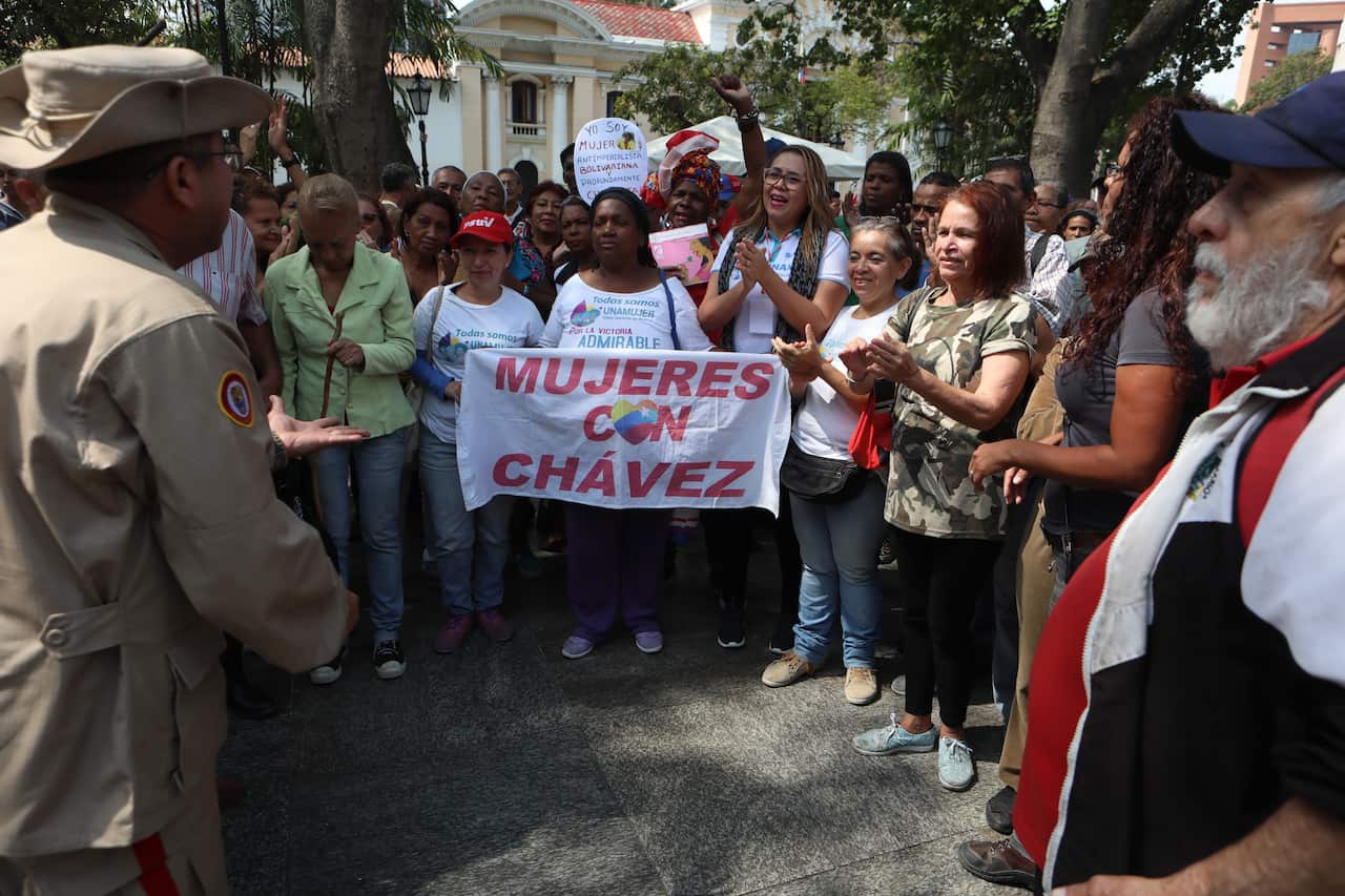 A group of people demonstrates in favor of President Maduro's Government, during a power outage in Caracas, Venezuela.