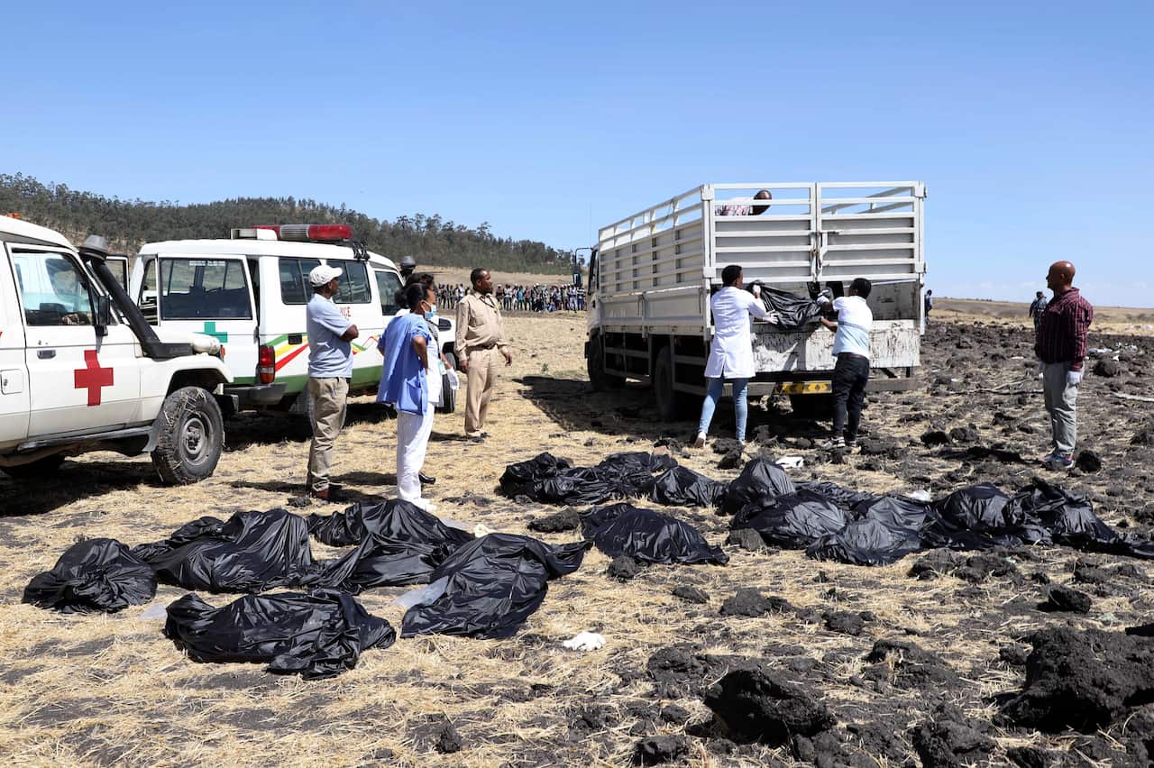 Rescuers remove body bags from the scene of an Ethiopian Airlines flight that crashed shortly after takeoff at Hejere near Bishoftu.