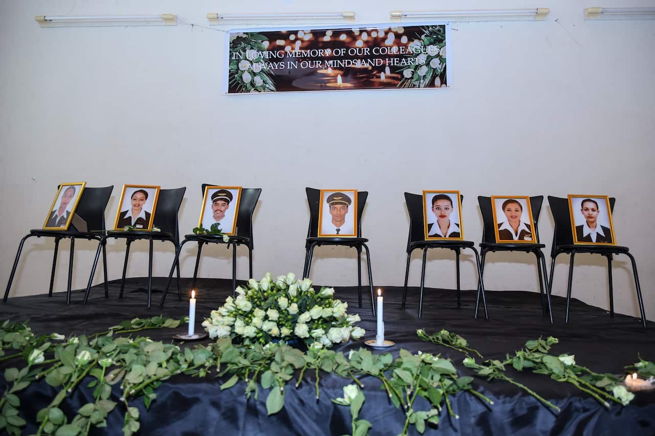 Photographs of the crew members of the Ethiopian Airlines flight ET 302 that crashed are displayed during a memorial service.