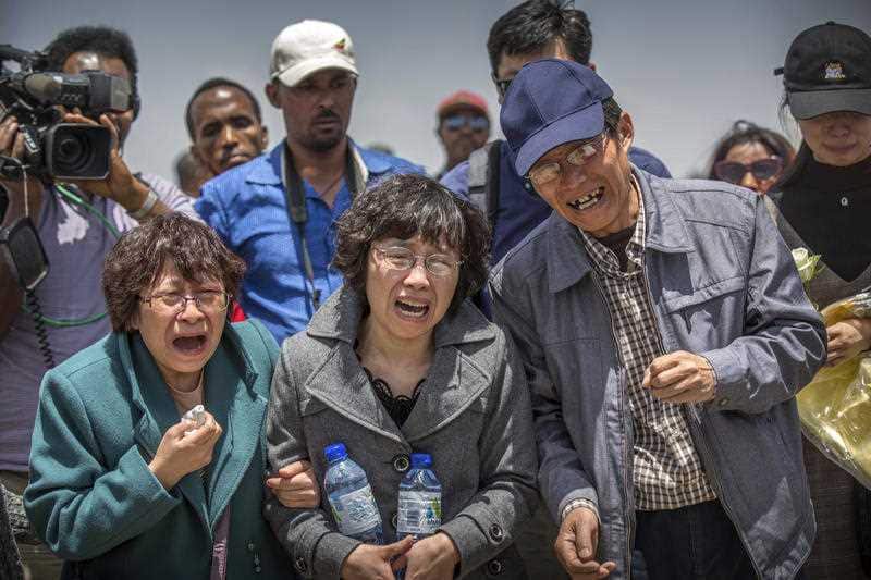 Relatives react at the scene