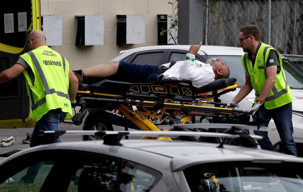 Ambulance staff take Mohsen Al-Harbi from outside a mosque in central Christchurch, New Zealand, Friday, March 15, 2019.  A witness says many people have been killed in a mass shooting at a mosque in the New Zealand city of Christchurch.