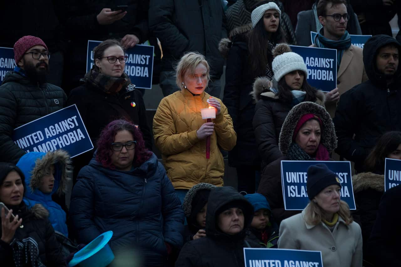 People gather for a vigil held for the victims of the New Zealand mass shooting in Toronto.