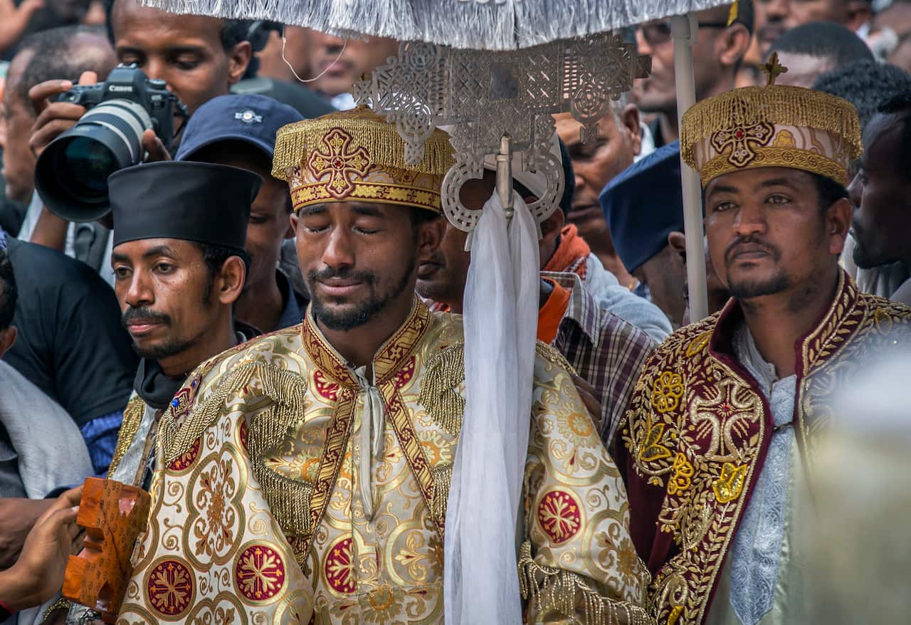 A priest cries at a mass funeral ceremony and procession held for the Ethiopian victims of the Ethiopian Airlines crash in Addis Ababa.
