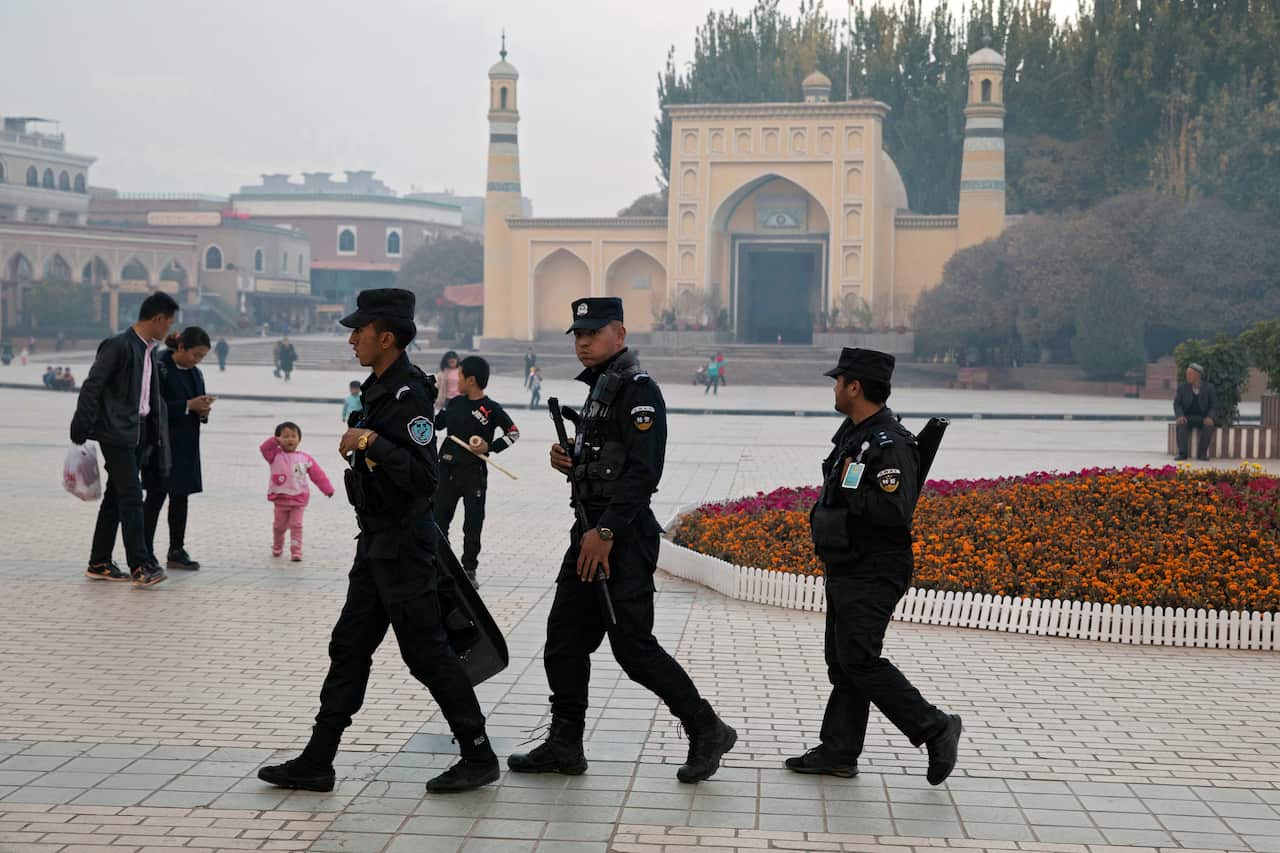 Uighur security personnel patrol near the Id Kah Mosque in Kashgar in western China's Xinjiang region.