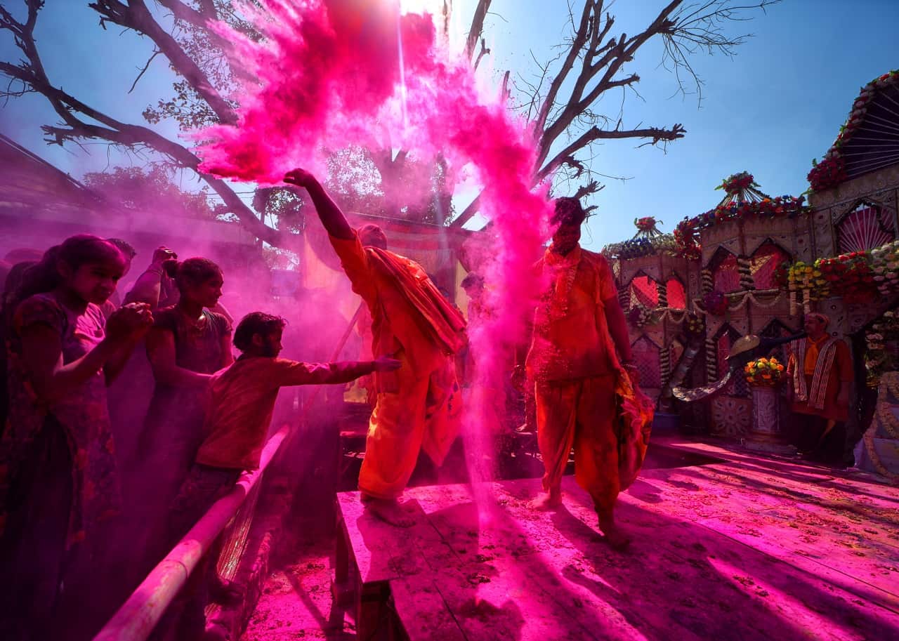 Hindu devotees are seen playing with Colourful powders and water during the Holi Festival celebration at Gokul dham, Mathura. .