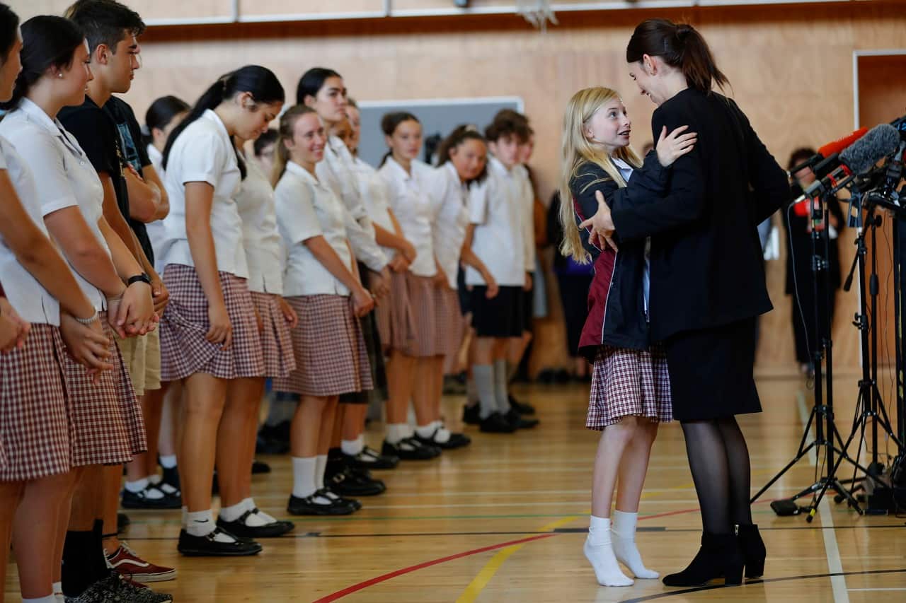 New Zealand's Prime Minister Jacinda Ardern hugs a student on Wednesday.