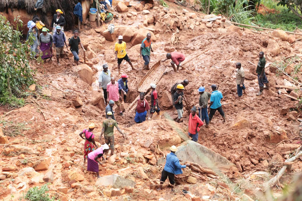 A family dig for their son who got buried in the mud when Cyclone Idai struck in Chimanimani about 600 kilometres south east of Harare, Zimbabwe.