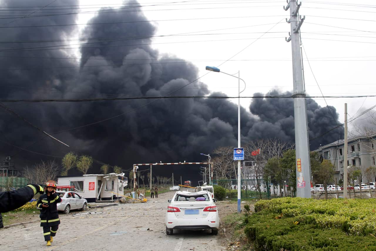 Firefighters walk past the site of a factory explosion in a chemical industrial park in Xiangshui County of Yancheng in eastern China's Jiangsu province.