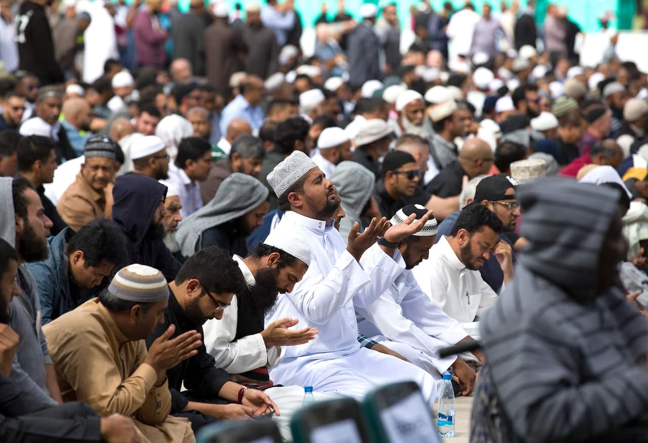 Muslims answer the call to pray at Hagley Park, opposite the Al Noor Mosque, one of the mosques hit by a gunman, Christchurch, New Zealand.