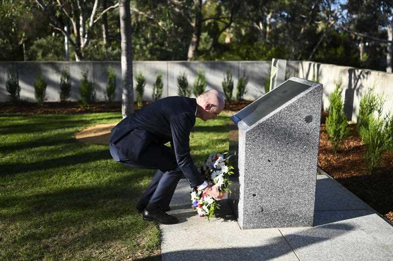 Dutch Minister of Foreign Affairs Stef Blok lays a wreath at the MH17 memorial plaque outside Parliament House in Canberra