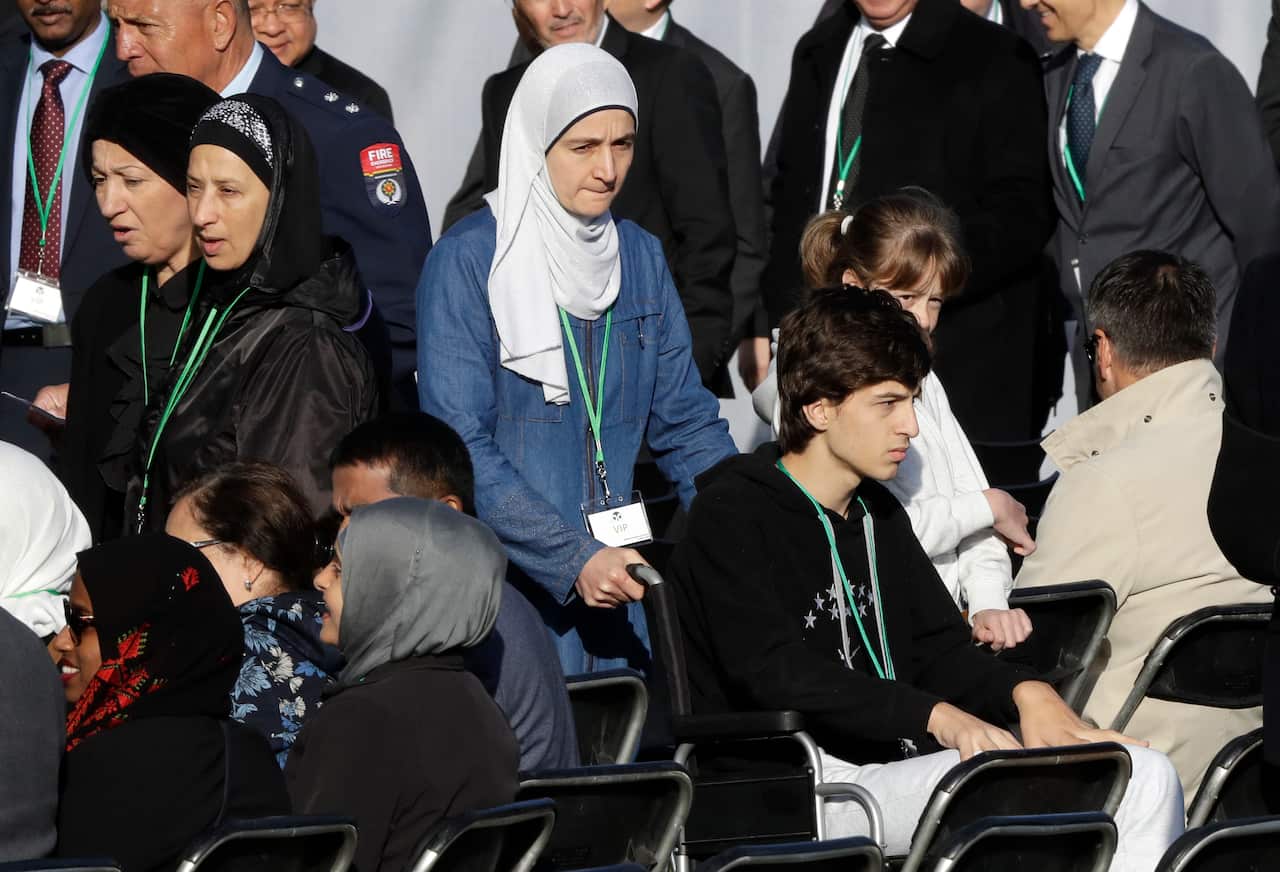 Mosque shooting survivor Zaid Mustafa, in wheelchair arrives with his mother to the National Remembrance Service in Hagley Park.