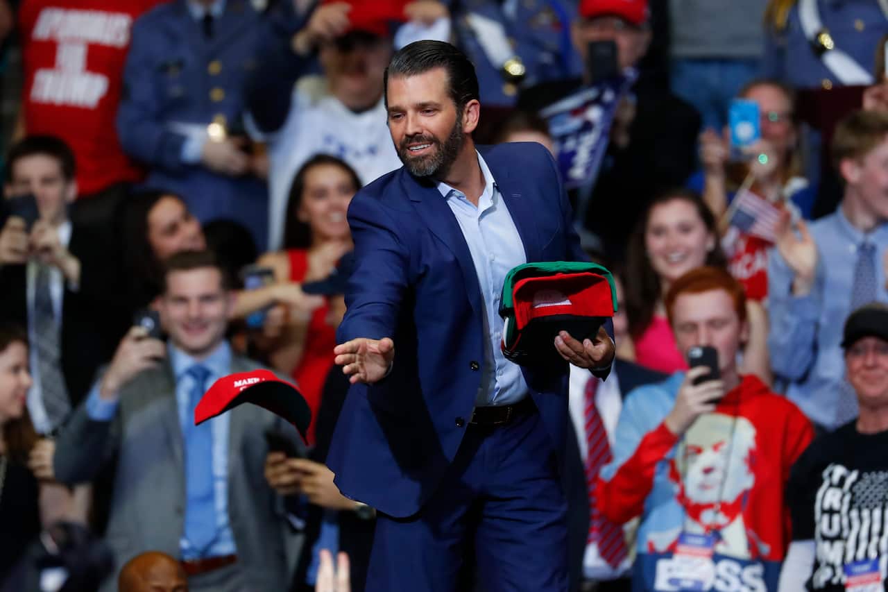 Donald Trump Jr. tosses hats to the audience during a rally in Grand Rapids, Mich., Thursday, March 28, 2019. (AP Photo/Paul Sancya)