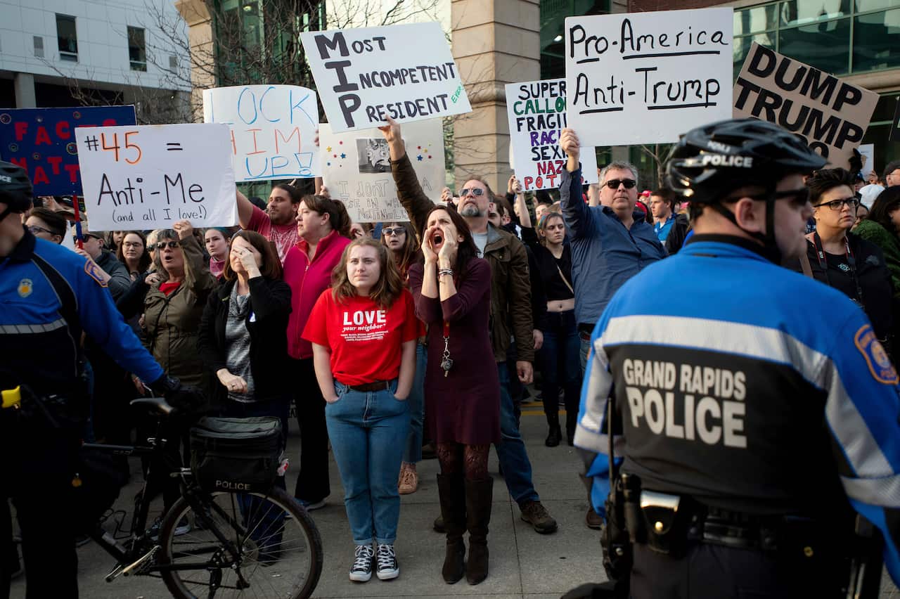 Protesters boo outside of Van Andel Arena as President Donald Trump is introduced at a rally in Grand Rapids, Mich., on Thursday, March 28, 2019. (Neil Blake/MLive.com/The Grand Rapids Press via AP)
