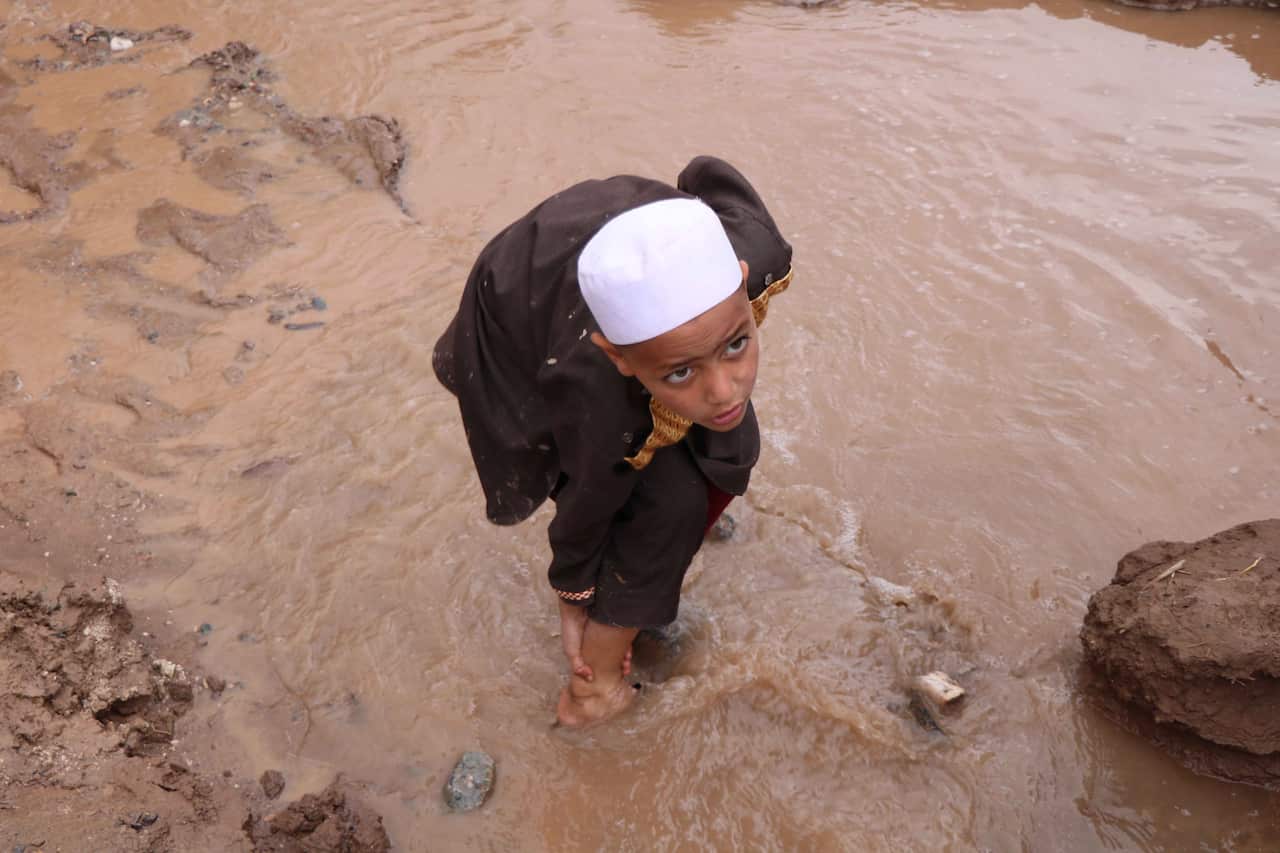 epa07470698 An Afghan boy makes his way through a flooded road in Herat, Afghanistan, 29 April 2019. According to local reports, at least 24 villagers were killed while dozens injured or missing in flash floods in western province of Afghanistan including