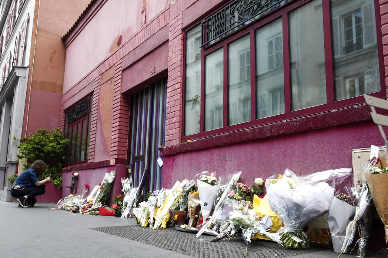 People lay flowers in front of French late director Agnes Varda's pink house, in Paris