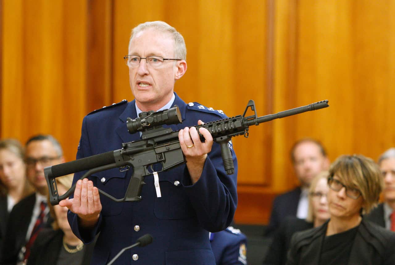 Police acting superintendent Mike McIlraith shows New Zealand lawmakers in Wellington an AR-15 style rifle similar to one of the weapons used by the gunman. 