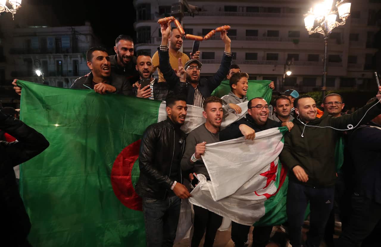 Algerian people celebrate on the streets after Algeria's President Abdelaziz Bouteflika has submitted his resignation
