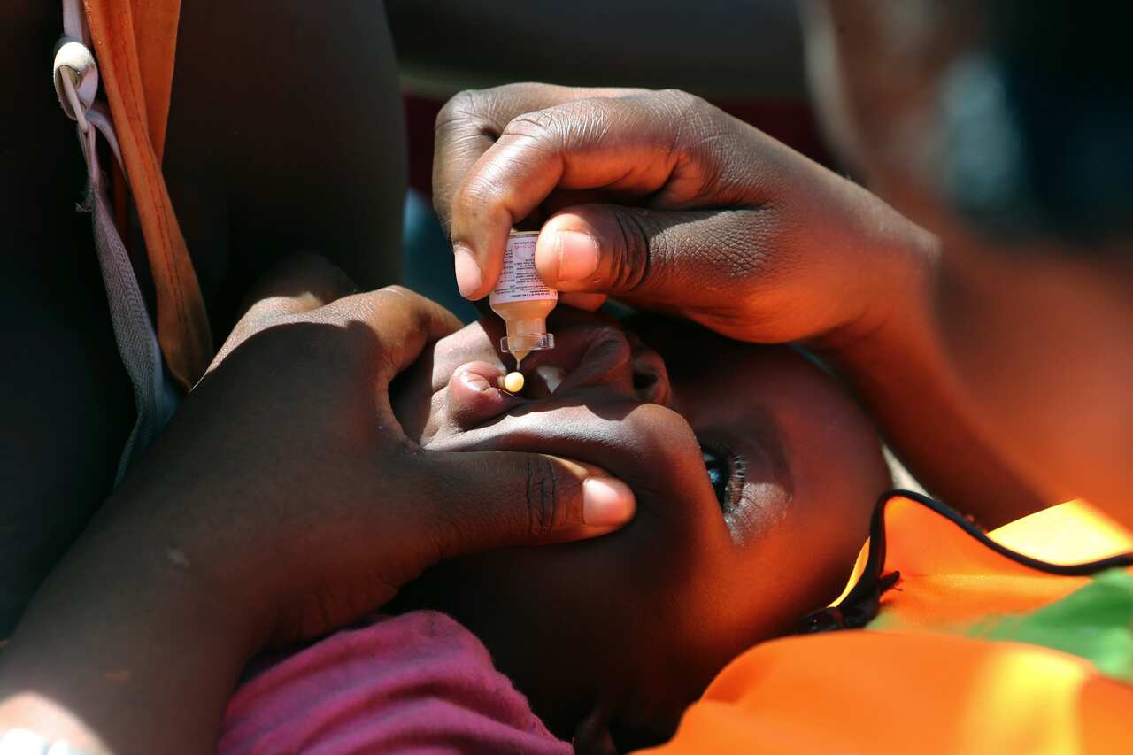 A baby recieves an oral cholera vacination.