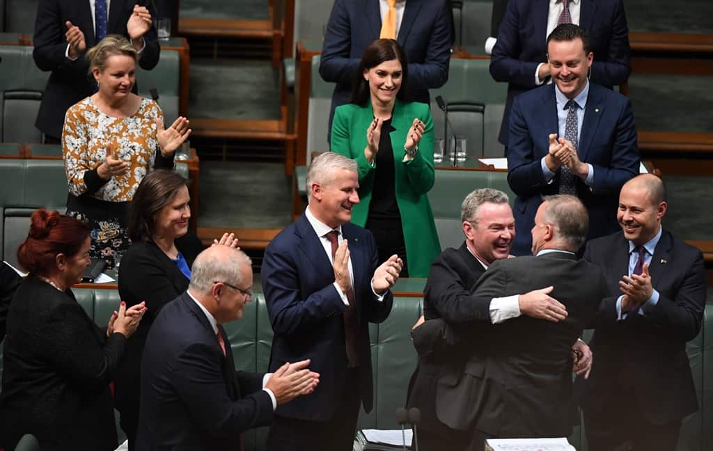 Shadow Minister for Infrastructure Anthony Albanese hugs Minister for Defence Christopher Pyne after his valedictory speech after Question Time in the House of Representatives 