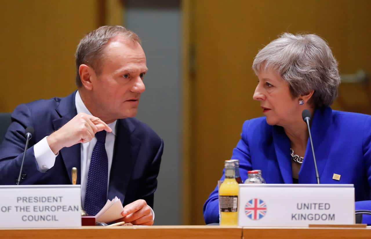 British Prime Minister Theresa May (R) and European Union Council President Donald Tusk (L) talk during the European council in Brussels, Belgium.